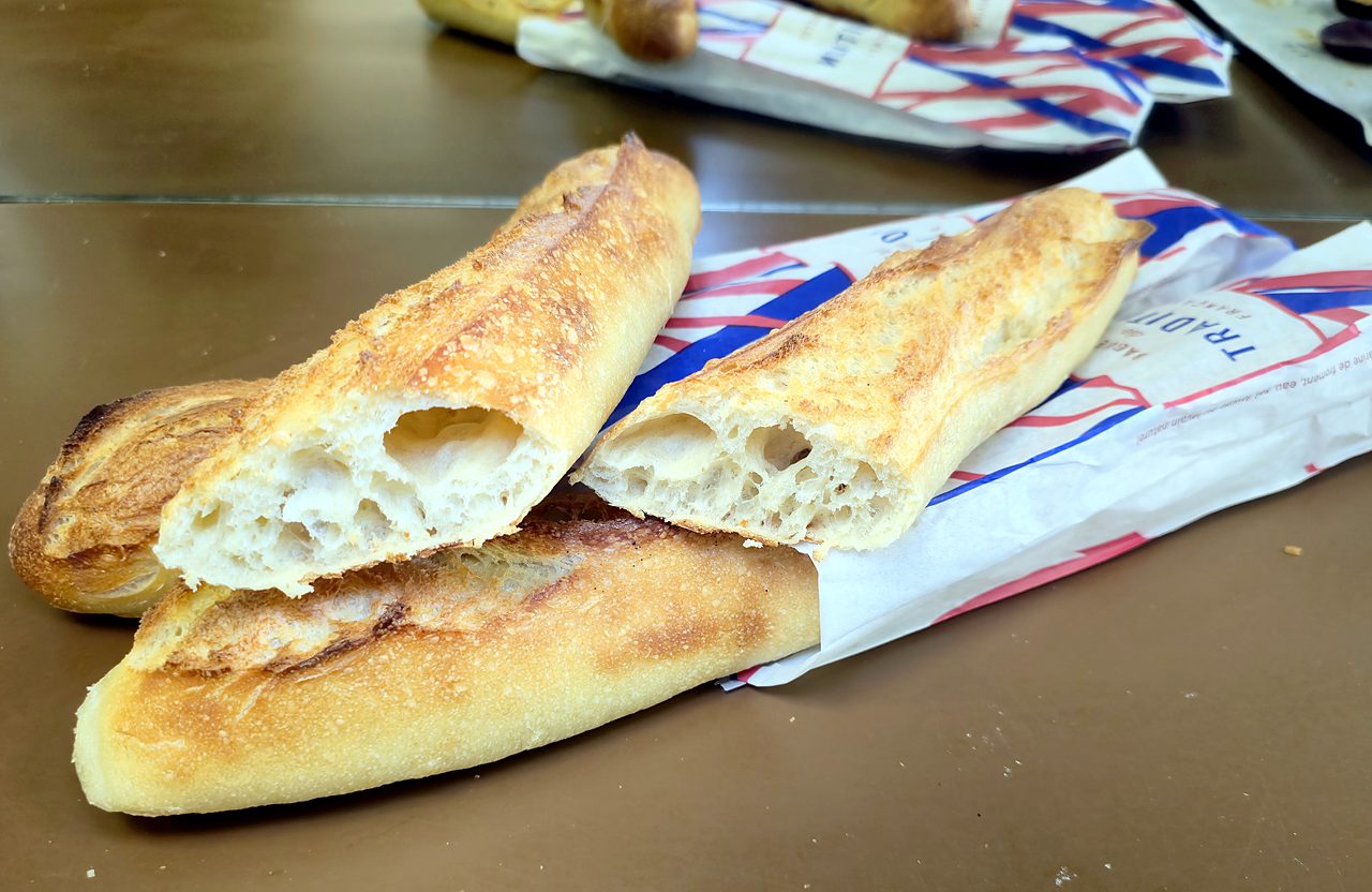 Baguette Tradition du Mistral coupée en deux, croûte dorée et mie alvéolée
